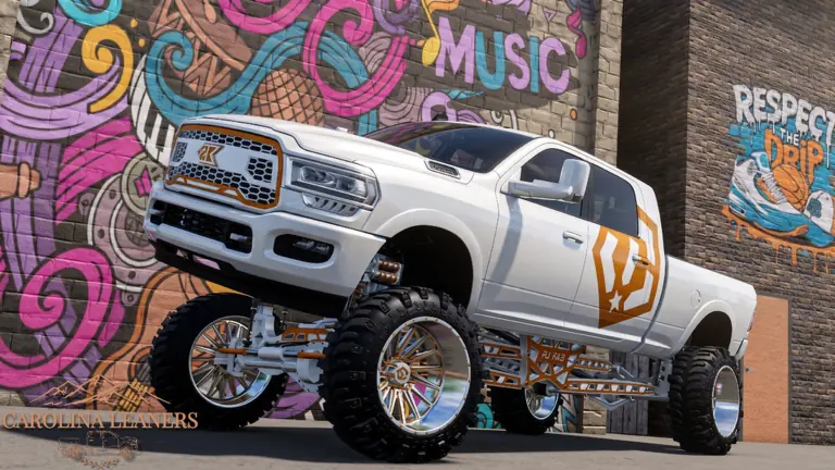 A lifted white heavy-duty pickup on oversized chrome wheels, parked in front of a painted mural.